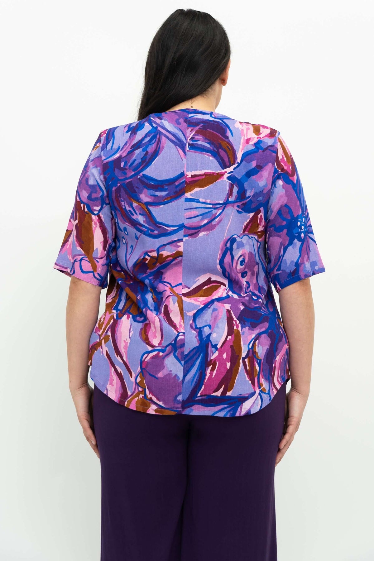 Back view of purple floral bamboo linen blouse showing shirt tail hemline