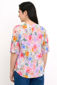 Back view of Liza floral bamboo linen blouse showing shirt tail hemline