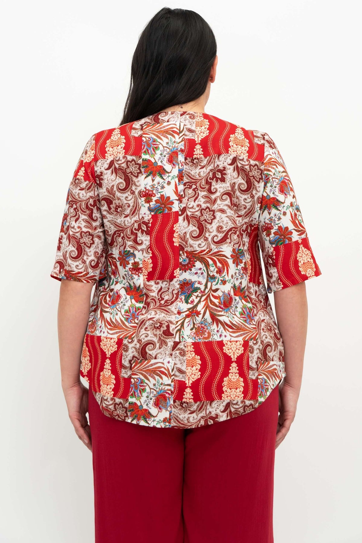 Back view of Liza paisley patchwork blouse showcasing shirt tail hemline