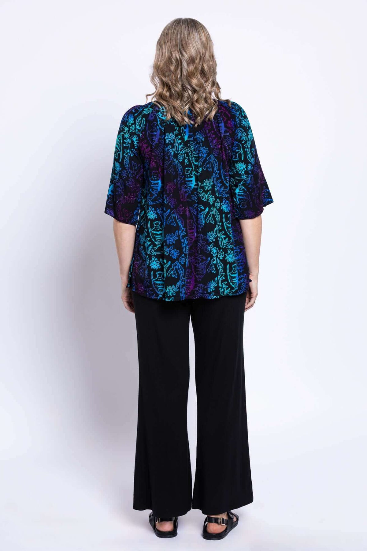 Back view of model in Luna Boho Peasant Top showing floral print
