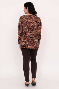 Back view of woman in leopard print long sleeve top and brown pants