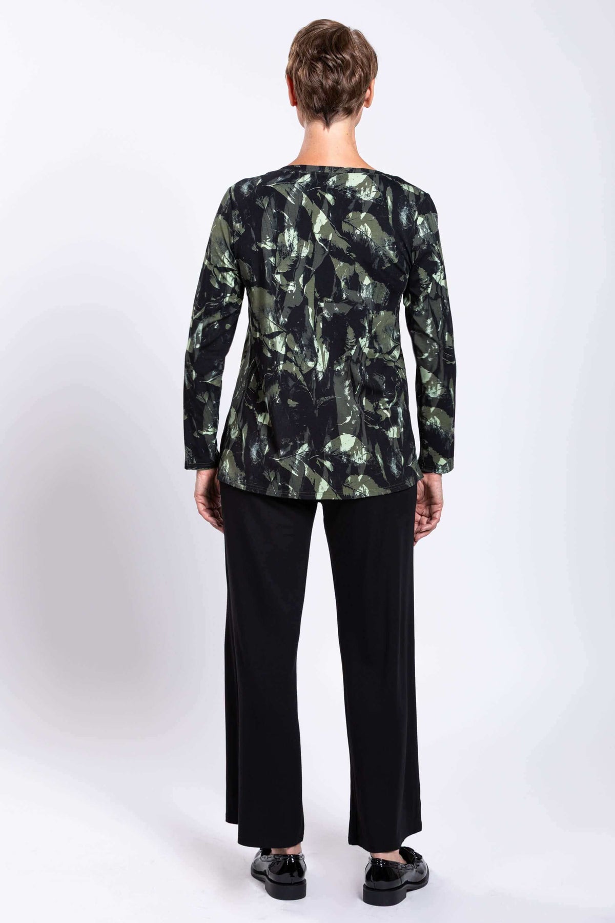 Back view of woman in Margie printed top displaying side seams and length