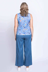 Back view of woman in blue floral tank top and wide-leg jeans