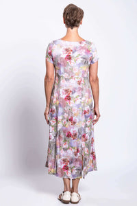 Back view of woman in a floral panel dress showing the back fit and length