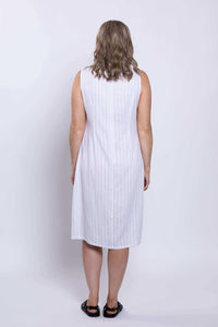 Back view of woman showing the length and fit of a sleeveless white striped dress