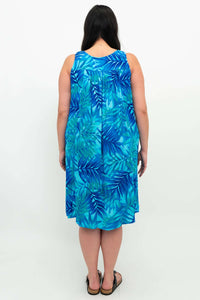 Back view of woman in blue leaf print sleeveless dress
