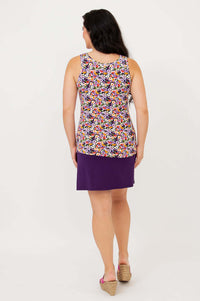Back view of woman in Reanna reversible bamboo tank with violet floral print and purple skirt