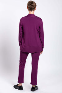 Back view of model showcasing plum bamboo pants and matching cardigan