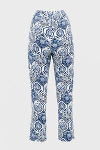 Back view of blue and white printed slim fit pants on plain background