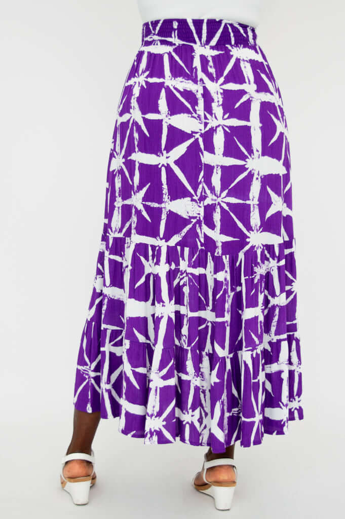 Model wearing purple and white patterned ankle-length skirt, back view