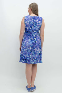 Back view of woman wearing a sleeveless blue floral Willow dress