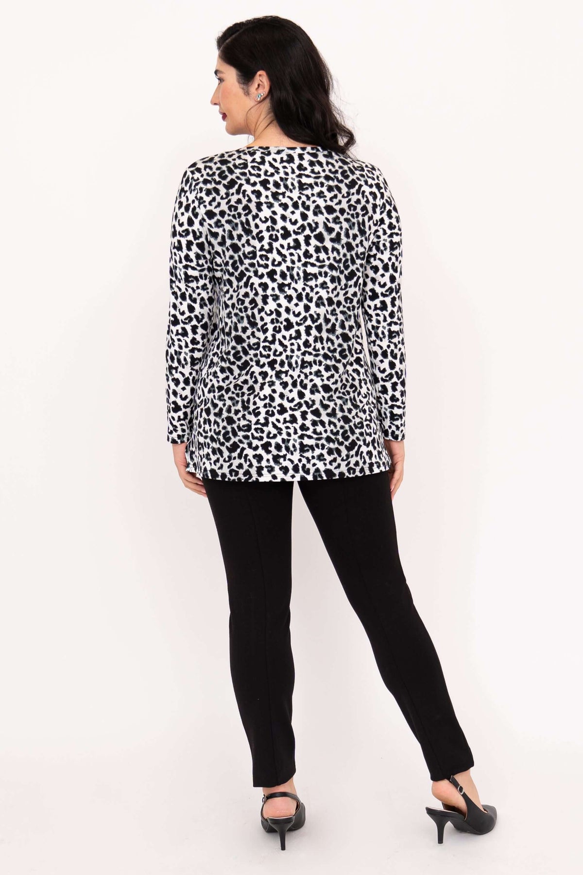 Back view of woman in long sleeve animal print tunic top showing side slits