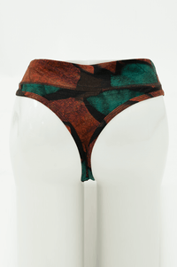 Back view of bamboo thong underwear featuring green and rust abstract pattern