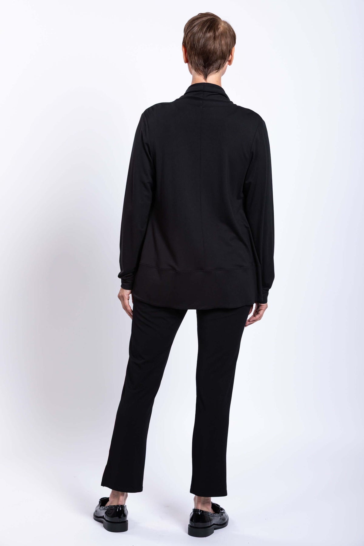 Back view of woman wearing a black French Terry jacket and black pants