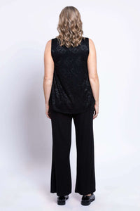 Back view of black lace overlay tank top worn with wide-leg pants