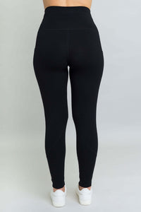 Rear view of woman wearing black petite fleece leggings