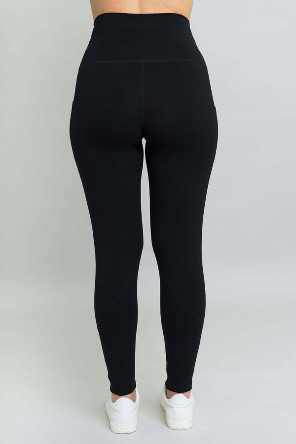 Rear view of woman wearing black petite fleece leggings