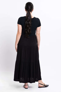Back view of woman in a black short sleeve maxi dress