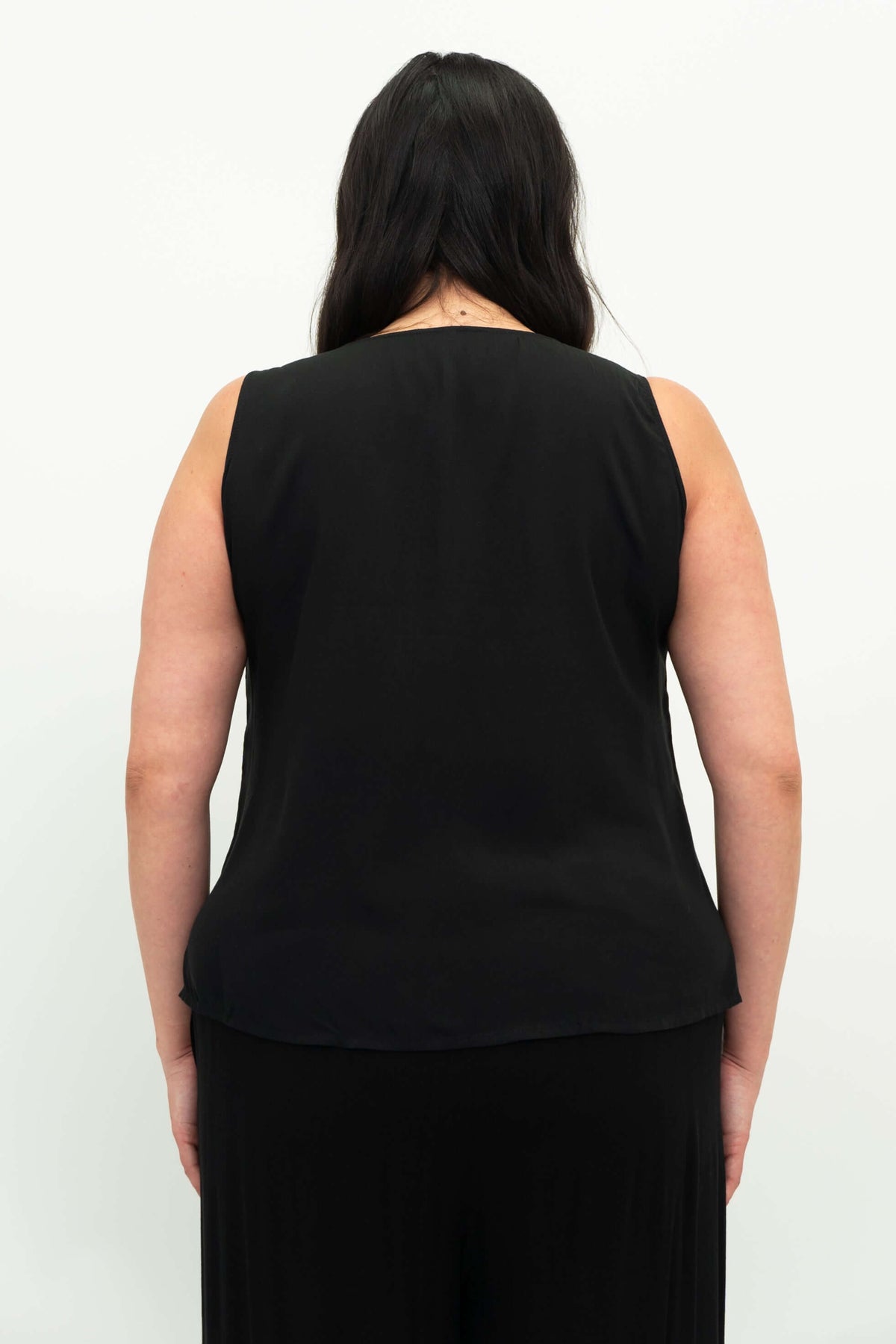 Back view of a woman wearing a black sleeveless tank top