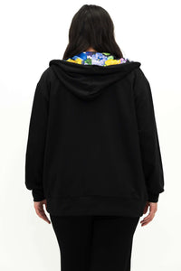 Back view of woman in black zip hoody showing collar with floral lining