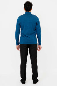 Back view of man wearing blue quarter-zip mock neck sweater and black trousers