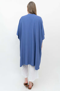 Back view of blue Darcy Kimono Wrap on woman in white pants