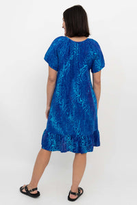 Back view of Samoa Dress showcasing flowy ruffle hem and botanical print