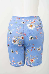 Back view of blue bamboo shorts featuring a vibrant floral pattern