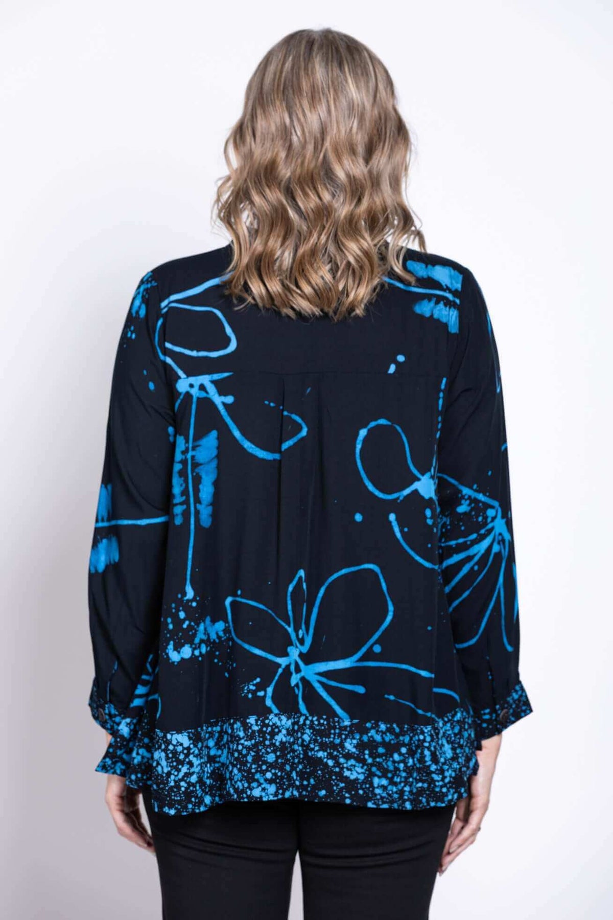 Back view of blue batik print blouse showing pattern and hem detail