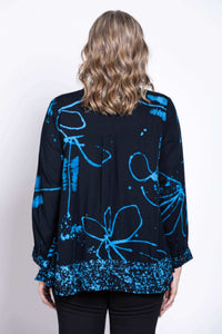 Back view of blue batik print blouse showing pattern and hem detail