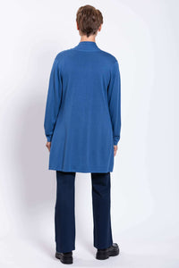 Back view of a woman in a blue cardigan and navy pants