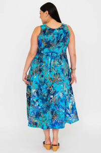 Back view of model in a blue floral A-line midi dress showing tie-belt detail