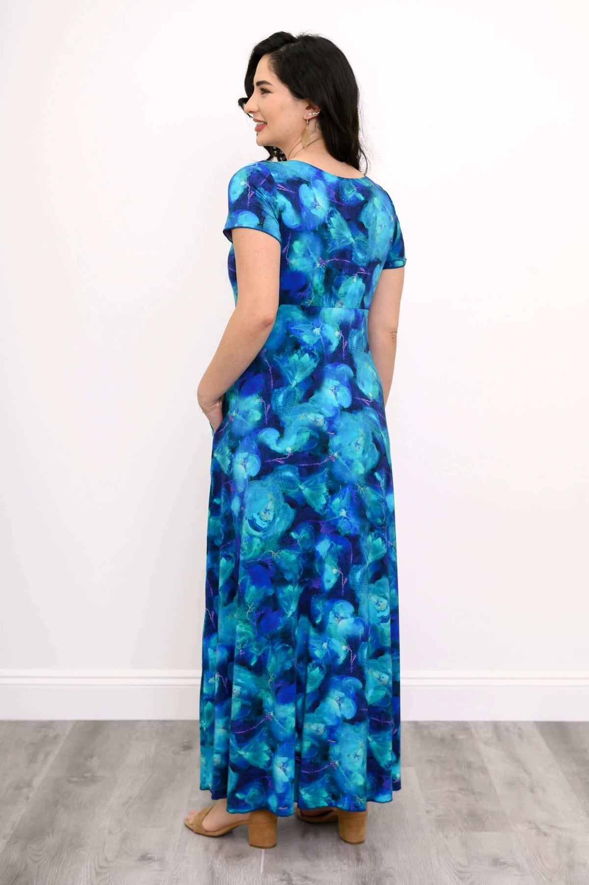 Back view of a blue floral bamboo maxi dress, showing short sleeves and relaxed fit