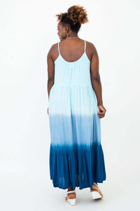 Back view of a woman wearing a blue ombre maxi dress with adjustable straps