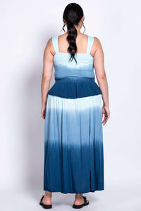 Back view of a blue ombre maxi dress showing smocked upper back and flared skirt
