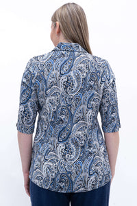 Back view of woman wearing blue paisley blouse with tailored seams