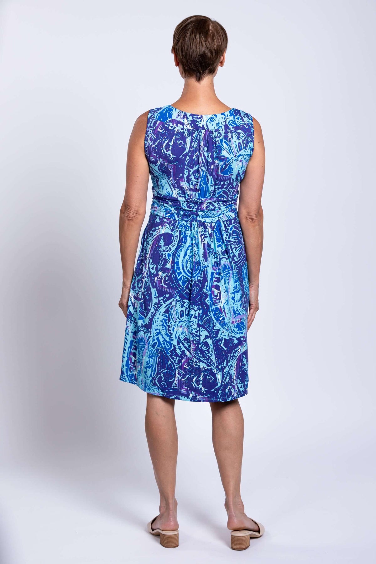 Back view of woman in blue patterned sleeveless Roam dress