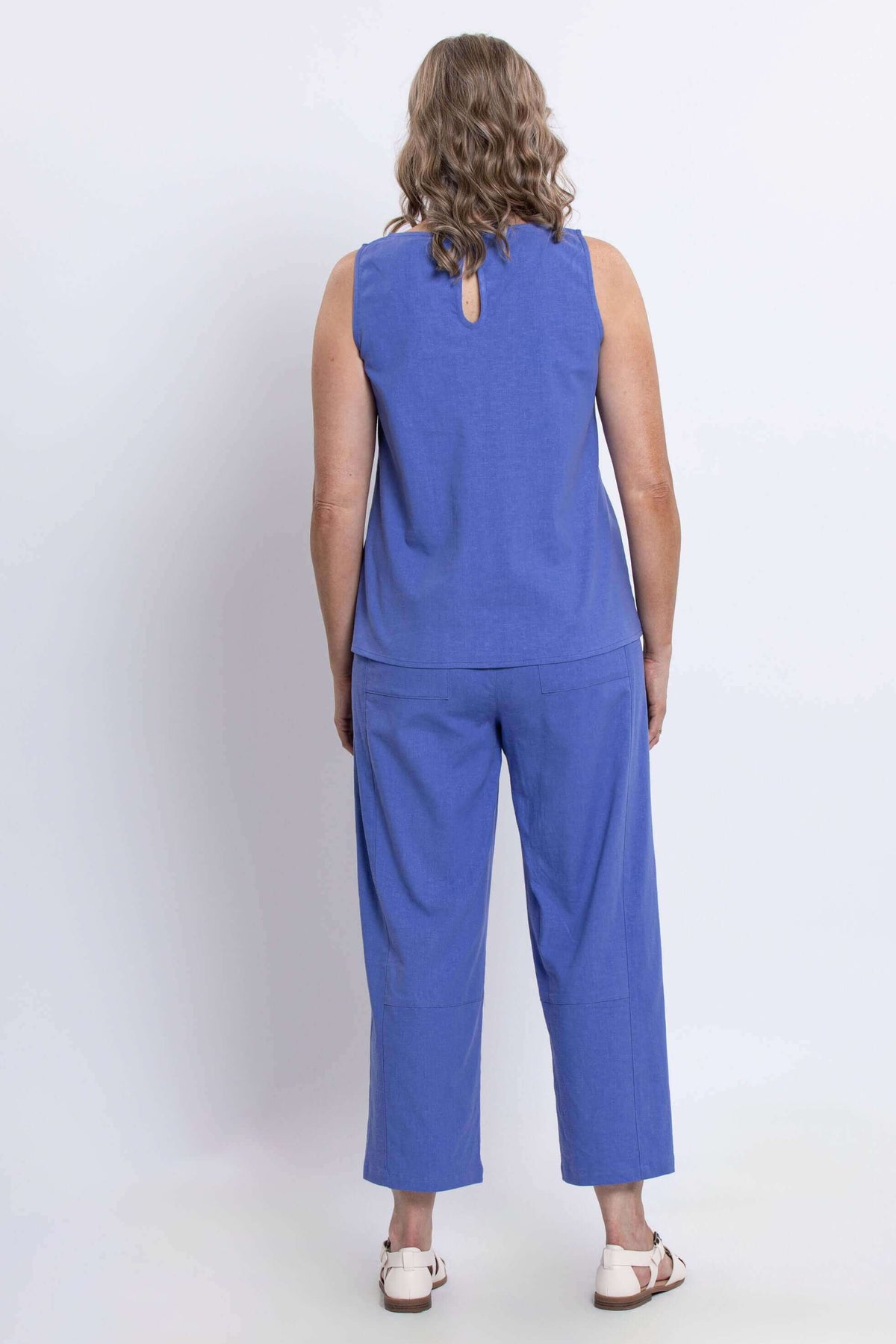 Back view of the blue sleeveless tank top showing the back button closure