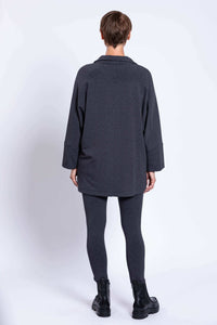 Back view of woman wearing charcoal Taran Jacket with relaxed fit and long sleeves