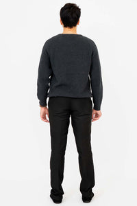 Back view of man wearing a charcoal ribbed crewneck sweater and black pants