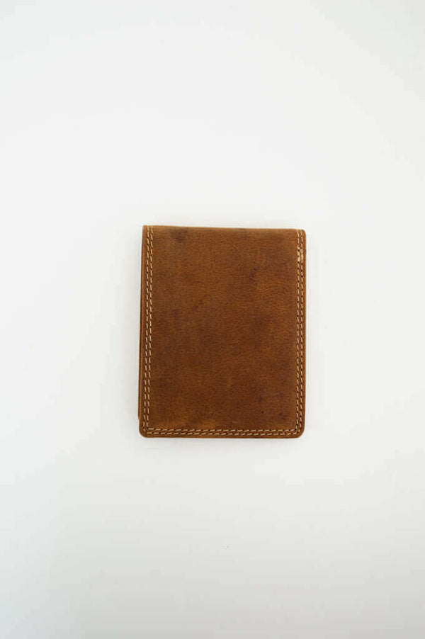 Rear view of a compact brown leather wallet on a white background