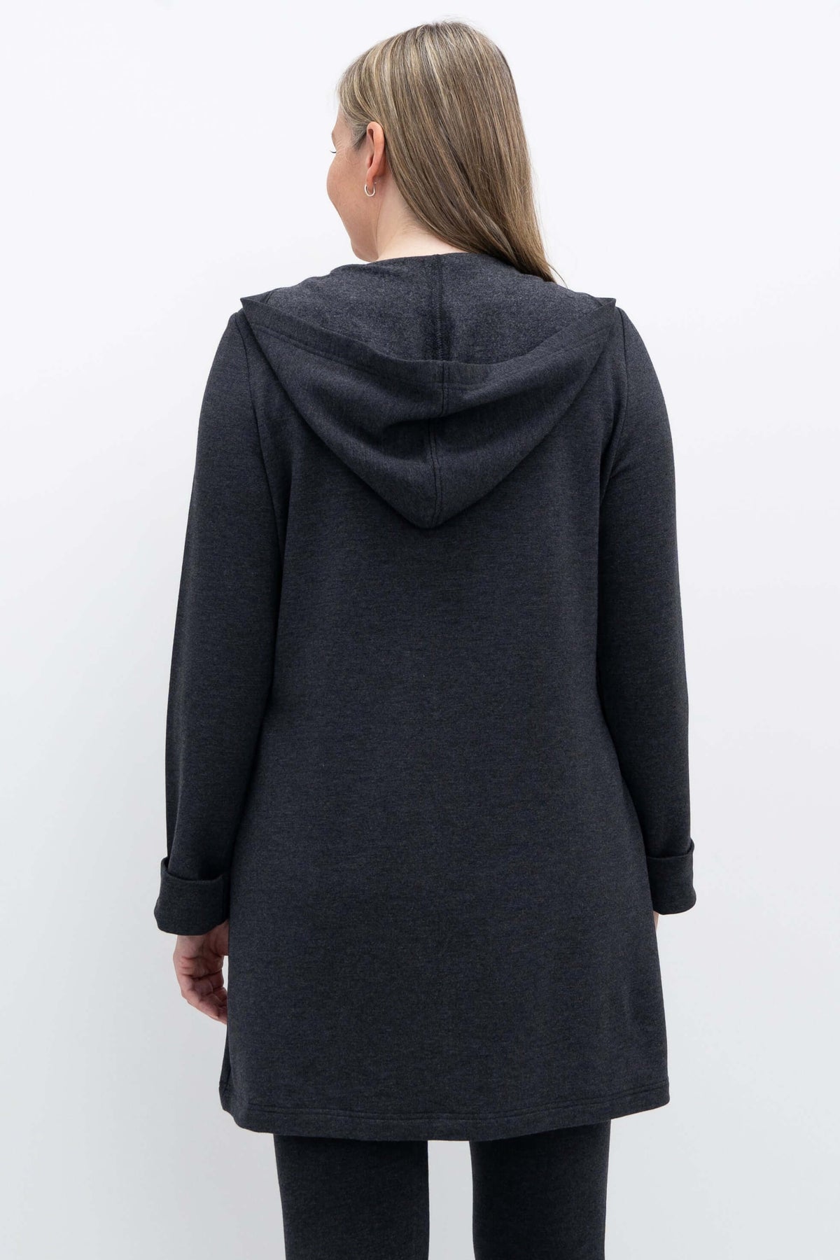 Back view of a woman wearing a dark grey hooded jacket
