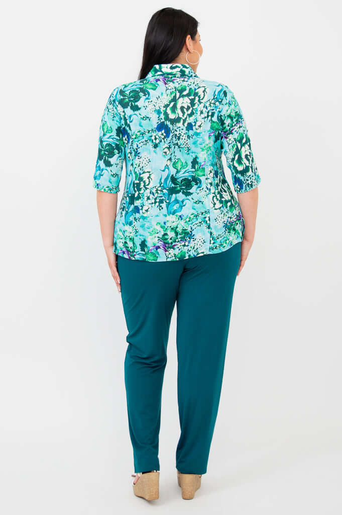 Back view of blue and green floral blouse, showing collar and elbow sleeves
