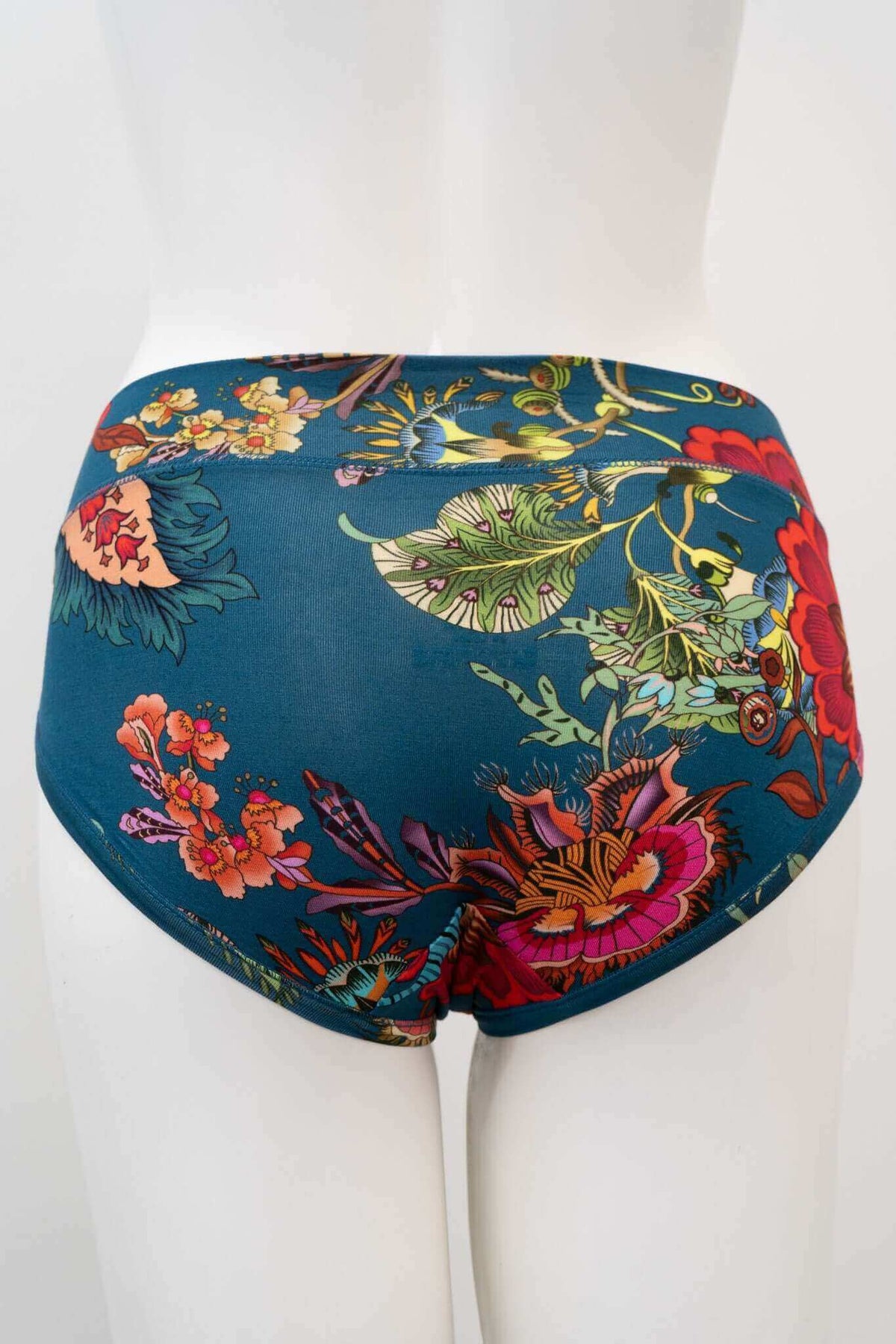 Back view of hipster underwear with colorful floral design on teal fabric