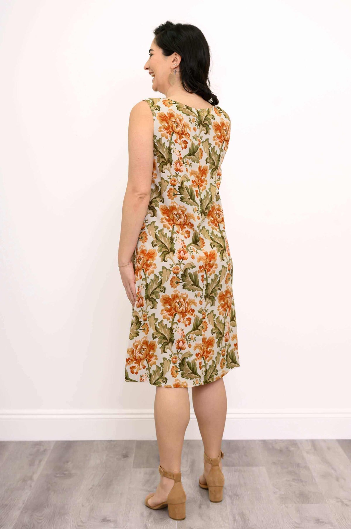 Back view of woman in floral knee-length dress showing dress details