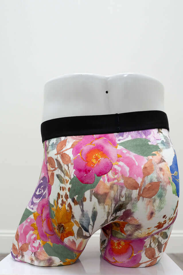 Back view of floral men's boxer briefs with black waistband and colorful design