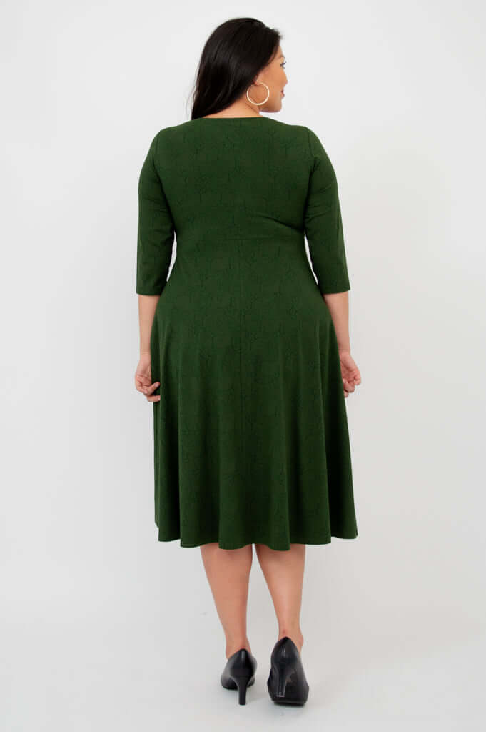 Back view of woman wearing forest green midi dress showing fit and length