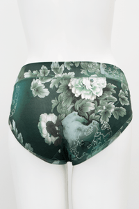 Back view of green hipster underwear featuring a detailed white floral print on mannequin