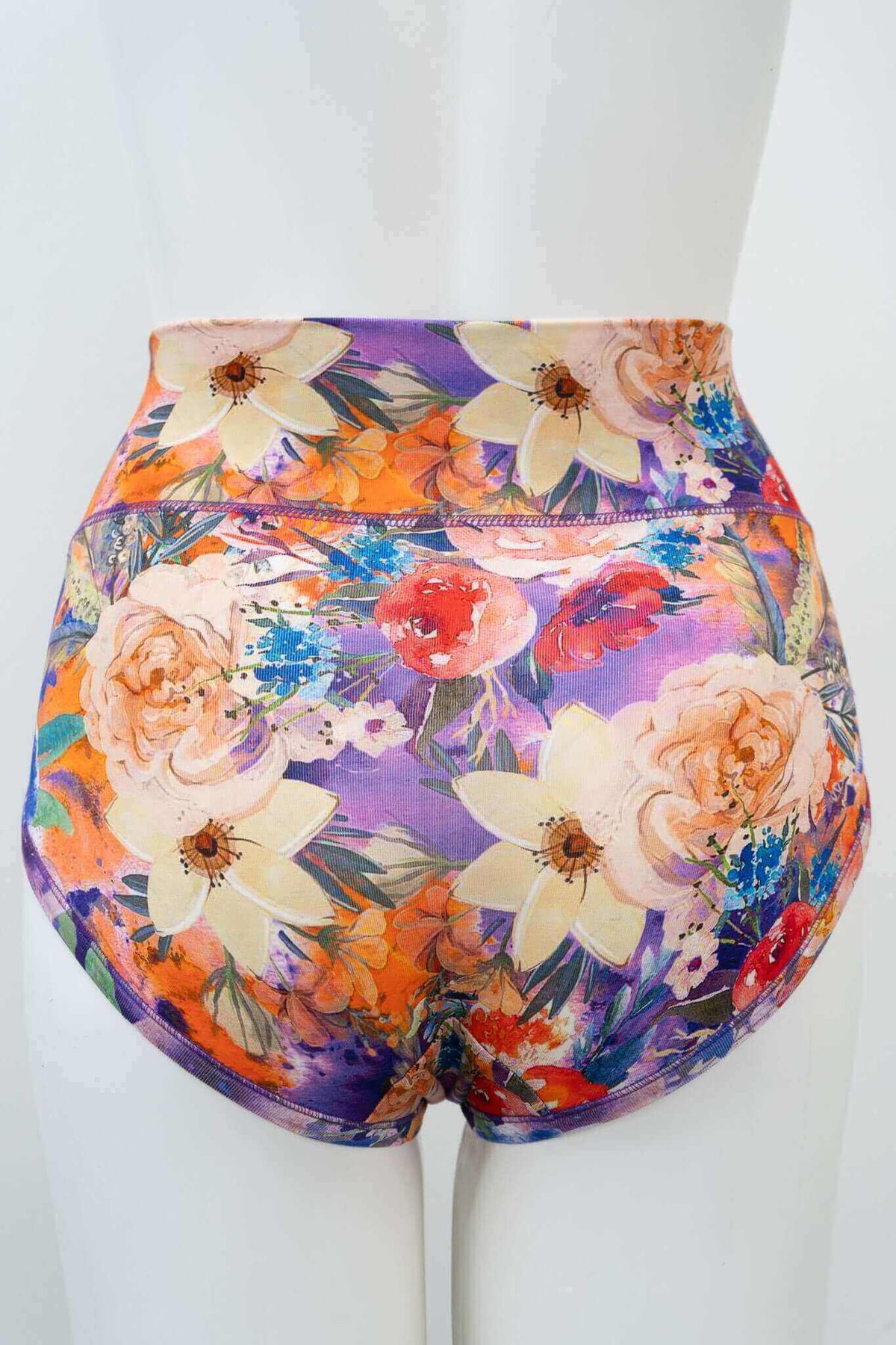 Back view of high-waist bamboo brief featuring bold floral design on mannequin