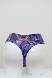 Back view of high rise bamboo thong underwear with purple floral print on mannequin